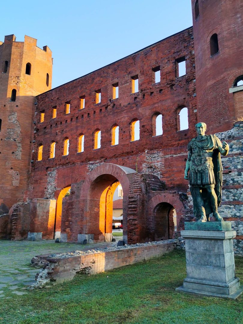 Turin's Porta Palatina, a beautifully preserved red-brick Roman gate guarded by the statues of Augustus and Caesar